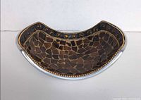 angled view showing interior brown and amber glass mosaic and rim cabochons