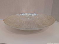 Side profile of shallow iridescent pressed glass bowl