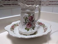 Pitcher inside matching basin showing overall set and floral pattern