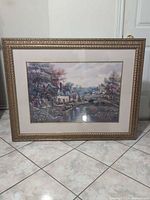 Front view of framed landscape print with ornate frame