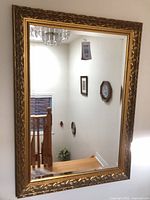 Front view of large gold framed mirror