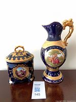 Front view of pitcher and lidded jar showing overall design and medallions