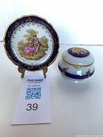 Front view of plate on brass stand beside trinket box