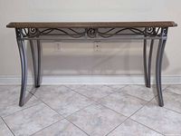 Front view of metal console table showing full structure