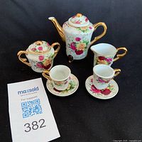 Front view of complete seven-piece miniature porcelain tea set