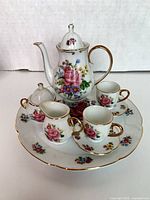 Full view of all miniature tea set pieces arranged on plate