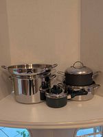 Group shot showing all five pots, steamer insert and lids