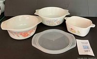 Group shot of three casseroles and plastic lid