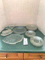 Overview of all pressed glass items on countertop