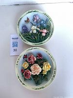 Both 7" floral porcelain wall plaques together