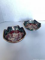 Top view of both porcelain bowls showing interior patterns and scalloped rims