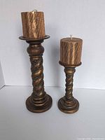 Pair of holders with candles displayed upright