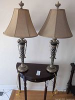 Two matching table lamps on table showing full view with shades