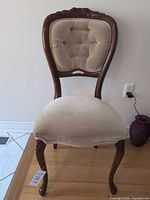 Full front view of chair showing frame, upholstery and legs