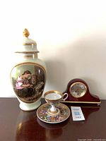 Group shot of urn, cup, saucer, and clock