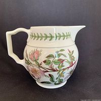 Left profile of Portmeirion Botanic Garden porcelain creamer jug showing floral design and spout