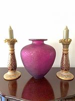 Front view vase flanked by both candlesticks with candles inserted