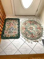 Round and rectangular rugs side by side at doorway