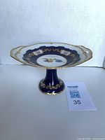 Top angle of Reichenbach porcelain compote showing floral medallion, cobalt blue glaze, gold gilt rim