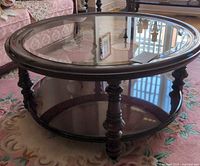 Round mahogany wood coffee table with glass inset top and lower shelf