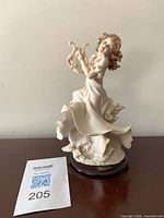 Front view of porcelain figurine with lot tag