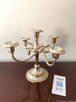 Front view of silver-toned 5-arm candelabra showing overall design and base