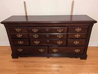 Front view of dresser showing drawer layout, hardware and finish