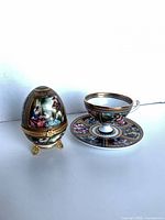 Group view of teacup, saucer and egg trinket box