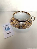 teacup on saucer showing interior, exterior pattern, handle style