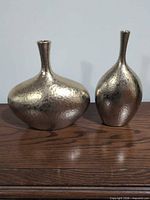 Front view of both hammered gold brass vases