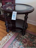 Full view of table front showing glass top, legs, lower shelf