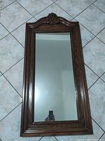 Front view of ornate wood wall mirror