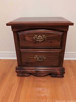 Front view of pine nightstand showing two drawers and brass-tone pulls