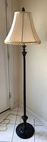 Full view of floor lamp showing base to shade