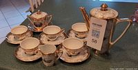 Full set showing all 15 porcelain pieces on counter