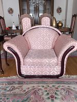 Front view of pink jacquard armchair with wood trim