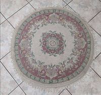 Full view of round floral carpet laid on tiled floor