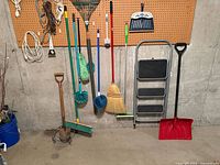Group of long-handled tools, step stool and snow shovel