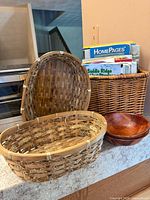 Group view of magazine holder, lidded basket, two wood bowls