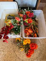 Two bins with assorted autumn artificial flowers, foliage and décor items