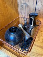 All components nested in wire basket: power handle, blending shaft, whisk attachment, chopper bowl, mixing cup