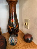 tall painted vase with two glass paperweights