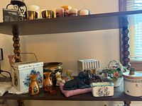Shelf with assorted figurines, vases, trinket boxes and tin