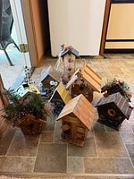 Group shot of nine decorative birdhouses showing overall variety