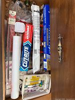 Drawer section with Reynolds paper rolls, HeatnBond roll, white paper roll, basket of trim spools