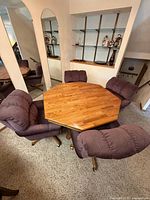 Aerial view of oak octagonal dining table with four upholstered swivel chairs