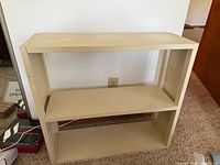 Front view of off-white two-shelf bookcase