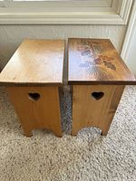 Two pine benches side by side, showing tops (one painted) and heart handles
