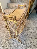 Three-quarter view of rattan magazine rack showing top shelf, lattice sides, and base