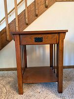 Front view of oak Mission end table showing drawer and shelf